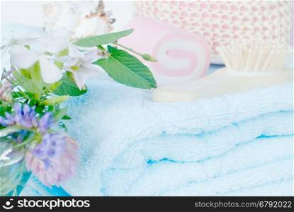 Spa setting with a blue towel and flowers