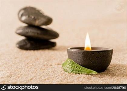 Spa still life burning candle with zen stones