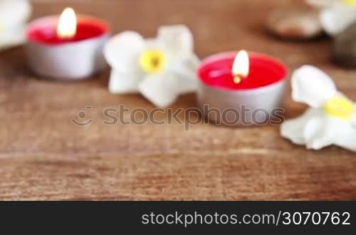 Spa still life containing bath salt rocks massage oil candles and flowers