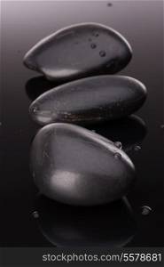 Spa stone arrangement on black surface. Healthcare concept.