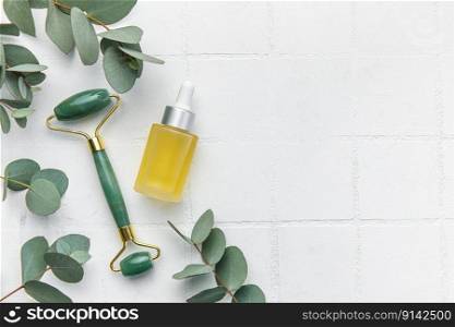 Spa treatment concept. natural spa cosmetics∏ucts with eucalyptus oil, massa≥jade rol≤r, eucalyptus≤af. Massa≥and spa concept