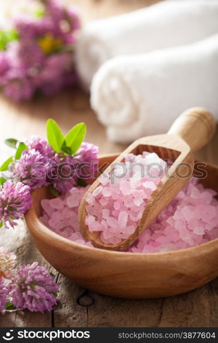 spa with pink herbal salt and clover flowers