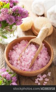 spa with pink herbal salt and clover flowers