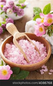 spa with pink herbal salt and wild rose flowers