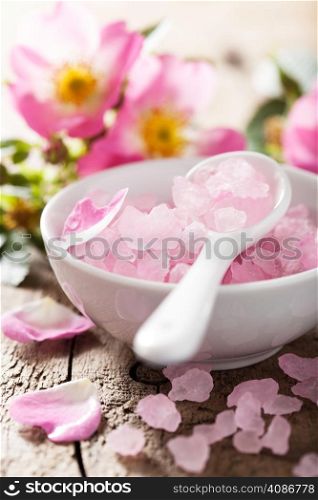 spa with pink herbal salt and wild rose flowers