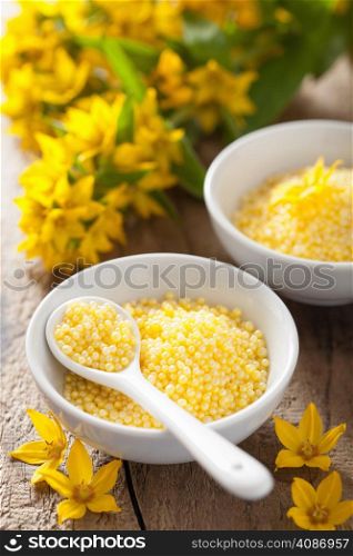 spa with yellow herbal bath pearls and flowers