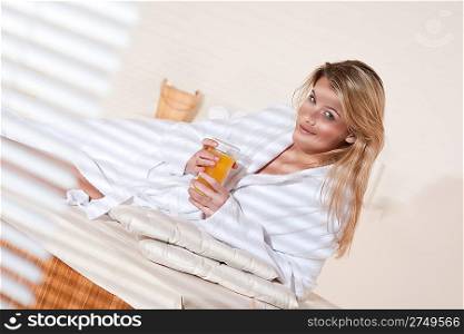 Spa - Young woman at wellness massage treatment therapy with orange juice