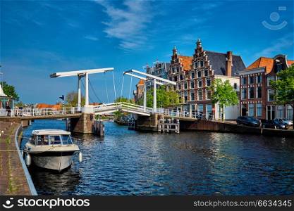 Spaarne river with boat and Gravestenenbrug bridge famous tourist landmark in Haarlem, Netherlands. Spaarne river with boat and Gravestenenbrug bridge in Haarlem, N