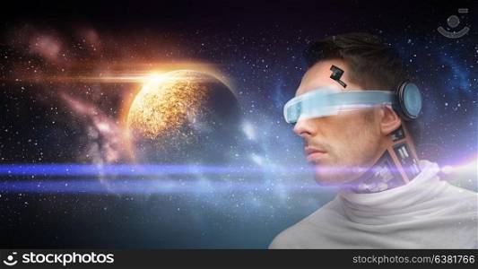 space, future technology and virtual reality concept - male robot in 3d glasses and microchip implant or sensors over planet and stars background. male robot in 3d glasses and sensors over space