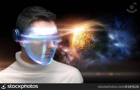 space, future technology and virtual reality concept - man in futuristic 3d glasses over planet and stars background. man in 3d glasses over planet and space