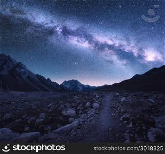 Space. Milky Way and mountains. Fantastic view with mountains and starry sky at night in Nepal. Trail through mountain valley and sky with stars. Himalayas. Night landscape with bright milky way