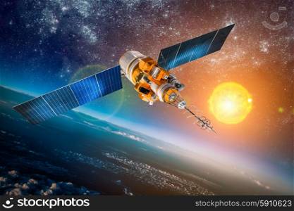 Space satellite orbiting the earth on a background star sun. Elements of this image furnished by NASA.