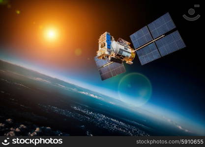 Space satellite orbiting the earth on a background star sun. Elements of this image furnished by NASA.