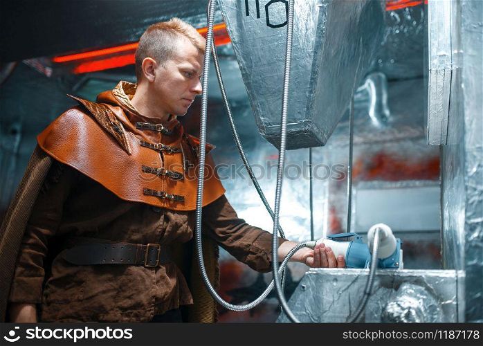 Space scientist holds an unusual instrument, spacecraft with foil walls. Fantasy spaceship for interstellar travel, future science and technology. Space scientist holds an unusual instrument