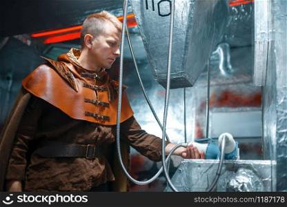 Space scientist holds an unusual instrument, spacecraft with foil walls. Fantasy spaceship for interstellar travel, future science and technology. Space scientist holds an unusual instrument
