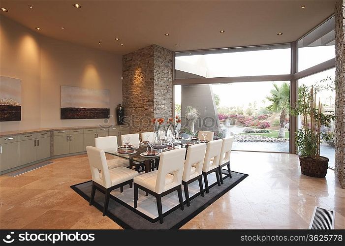 Spacious dining room and kitchen with floor to ceiling windows