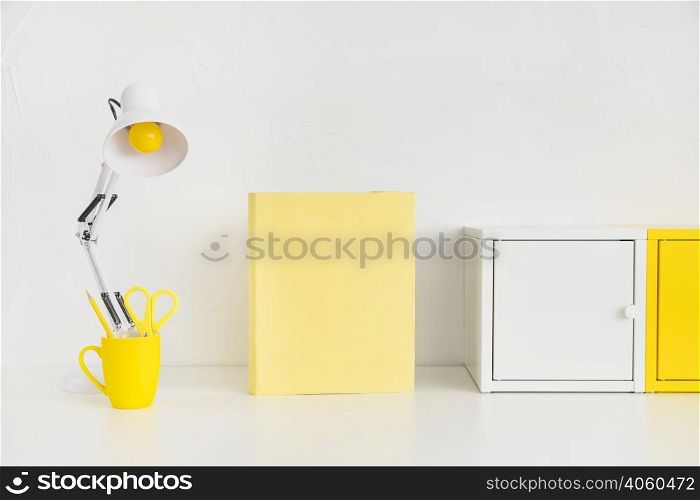 spacious workplace with metal boxes yellow notebook