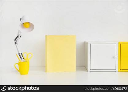 spacious workplace with metal boxes yellow notebook