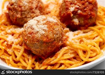 spagetthy and meatballs with tomato sauce and grated cheese
