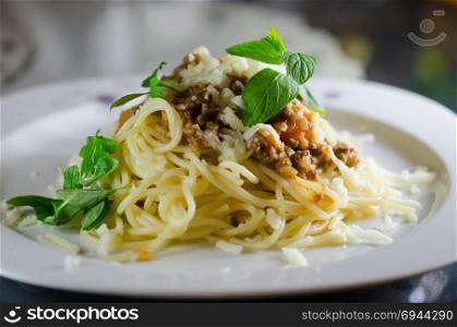 Spagetti bolognase on a white plate .