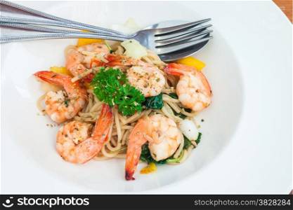 Spaghetti basil sauce with boiled shrimp in white plate