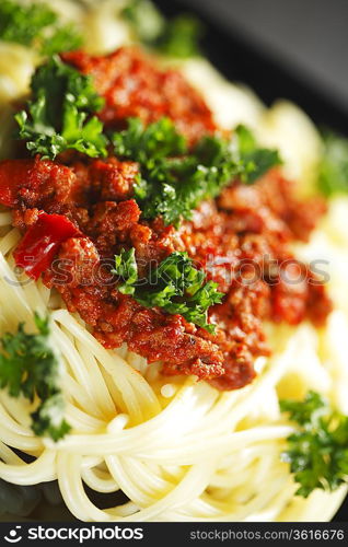 Spaghetti bolognese in black plate