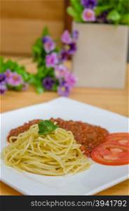 Spaghetti Bolognese meal with basil leaves and tomatoes. Spaghetti Bolognese meal