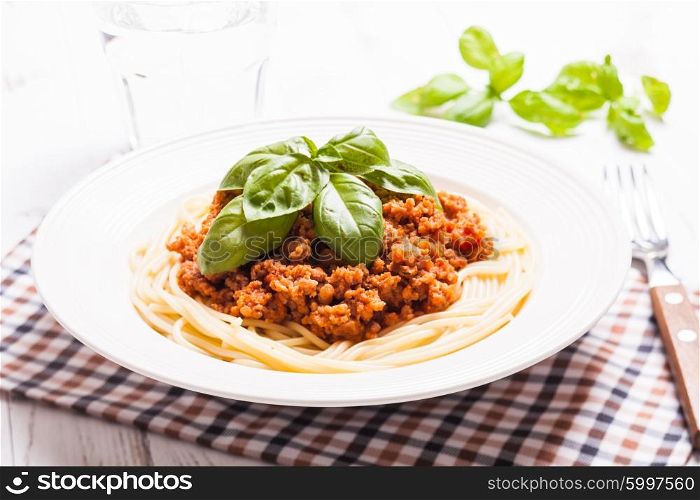Spaghetti bolognese on a plate and basil. The Spaghetti bolognese