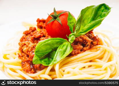 Spaghetti bolognese - pasta with tomato sauce and minced meat on white plate