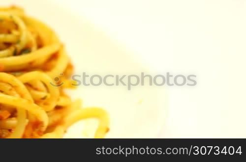 Spaghetti bolognese with cheese and spices on a plate