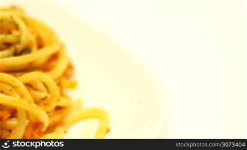 Spaghetti bolognese with cheese and spices on a plate