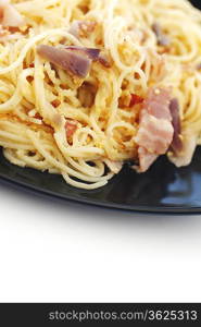 Spaghetti carbonara with fried bacon