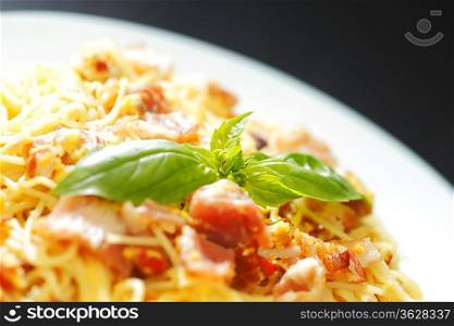 Spaghetti carbonara with fried bacon