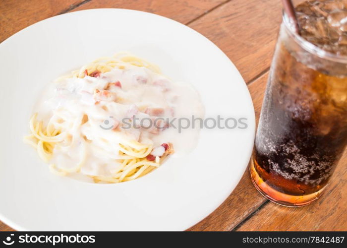 Spaghetti carbonara with ham cheese and cola, stock photo