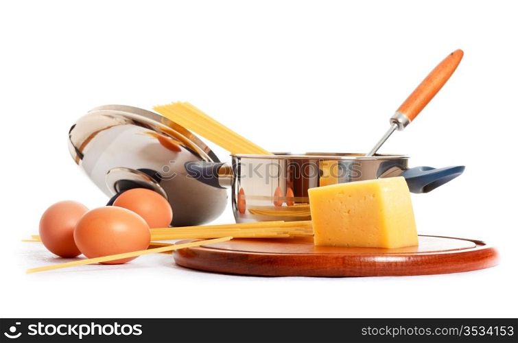 spaghetti, eggs and kitchen utensil on white background