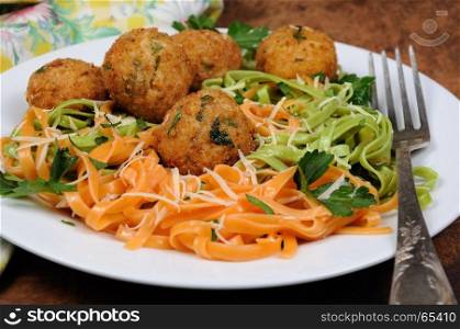 Spaghetti from carrots and spinach with chicken meatballs flavored cheese parmesan, herb