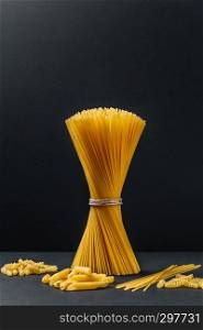 spaghetti in bunch on black background