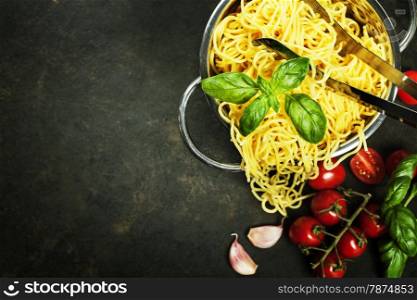 spaghetti in colander on dark vintage background