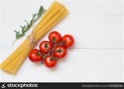 Spaghetti ingredients, tomato, rosemary, concept on white background top view. Pasta ingredients concept on white background, top view