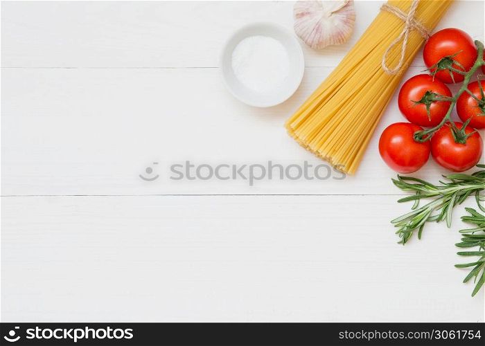 Spaghetti ingredients, tomato, rosemary, salt, garlic Concept on white background top view. Spaghetti ingredients concept on white background, top view