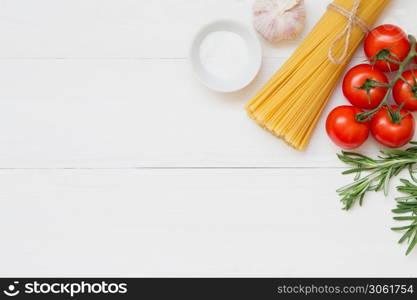 Spaghetti ingredients, tomato, rosemary, salt, garlic Concept on white background top view. Spaghetti ingredients concept on white background, top view