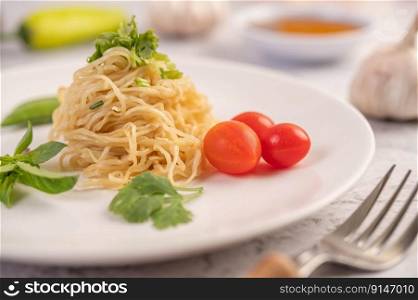 Spaghetti on a plate with tomatoes Coriander and basil. Selective focus.
