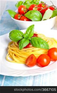 Spaghetti on the white plate with tomato sauce