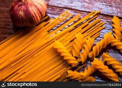 Spaghetti pasta and garlic on wooden table