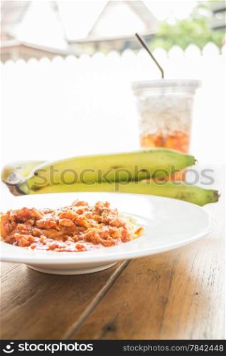 Spaghetti tomato pork sauce with fruit and drink, stock photo