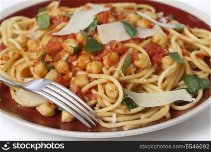 Spaghetti with a chickpea, tomato and chilli flakes sauce, garnished with fresh torn basil leaves and flakes of parmesan. This is a traditional Italian dish, which comes in many variations, with or without tomate or with chickpeas wholly or partly crushed into the sauce. It is called spaghetti alla ceci