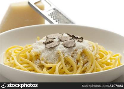 Spaghetti with black winter truffle and Parmesan cheese on a dish