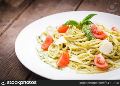 Spaghetti with green pesto, parmesan and cherry tomatoes