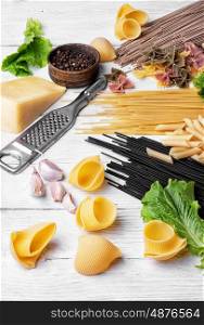 spaghetti with ingredients for cooking pasta. Large selection of uncooked spaghetti and macaroni on the kitchen table with ingredients