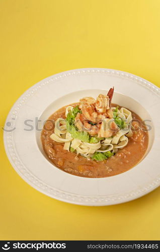 Spaghetti with prawns and vegetables on white dish , tomato sauce. Spaghetti with prawns and vegetables